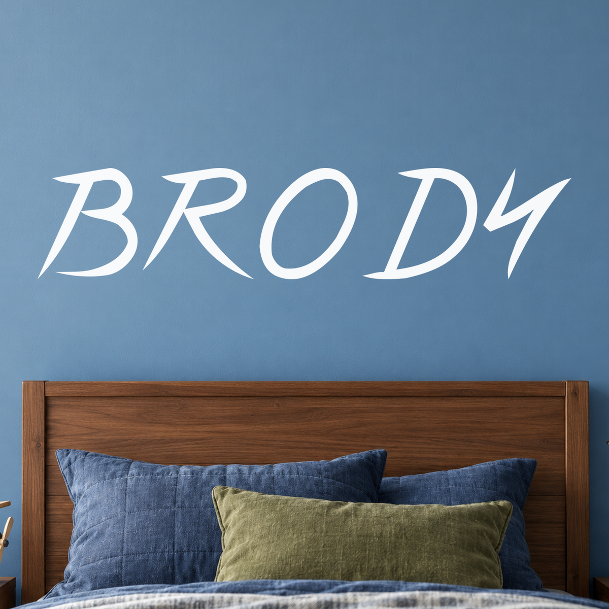 Close-up custom lettering example on a smooth wall